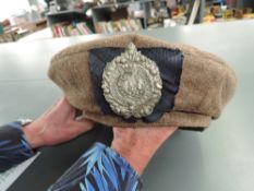 A WWII Tam O Shanter Cap to the Argyll and Sutherland Highlander Badge with Tartan backing, dated
