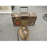 A wood and metal Ammunition box along with a canvas ammunitions belt with cartridges and bullets