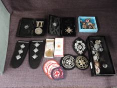 A collection of St John's Ambulance and Red Cross Medals, Badges and Epaulettes including Order of