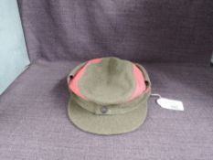 A WWII German SA M43 style Ski Cap, having metal flower to one side, Eagle holding Swastika Cap