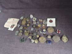 A collection of Badges in a Oxo tin including US Forces in Austria, Welsh Guards Old Comrades,