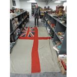 A Royal Navy White Ensign/Battle Flag, rope attached, no marking seen, 165cm x 365cm