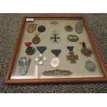 A framed display containing 17 German WWII Medals and Badges with vendor list including Close Combat