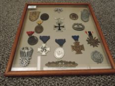A framed display containing 17 German WWII Medals and Badges with vendor list including Close Combat