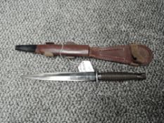A Post War Wilkinsons 3rd Pattern F.S.Commando Knife with leather and metal scabbard, blued blade