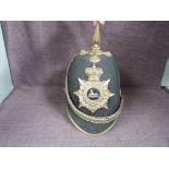 A late 19th/early 20th century Gloucester Regiment Black Cloth Spiked Helmet with cap badge and chin