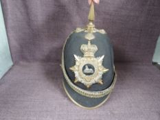 A late 19th/early 20th century Gloucester Regiment Black Cloth Spiked Helmet with cap badge and chin