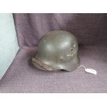 A German WWII Steel Helmet, possible M40 Luftwaffe, having leather liner and chin strap, no