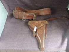 A brown Military Leather Belt with Holster, holster marked Nburshard Passing 16 also in pen