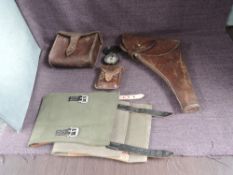 A military related collection, Leather Holster, pair of Canvas Puttees, Compass in leather case by C