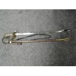 A British Naval Officers Sword with metal scabbard, sword has lion's head pommel and enclosed hilt