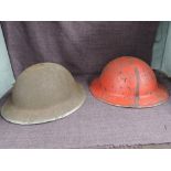 Two Steel Helmets, possibly British, one red, no markings seen