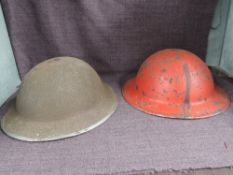 Two Steel Helmets, possibly British, one red, no markings seen