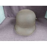 A German WWI Steel Helmet having leather liners, no markers marks or decals seen