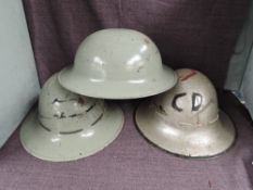 Three British Steel Helmets, first silver helmet has painted CD and Lighning Bolt with leather liner