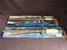 Two modern reproduction German WWII Daggers with scabbards in card boxes