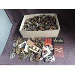 A large collection of metal Military Badges & Buttons, needs viewing