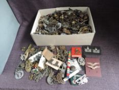 A large collection of metal Military Badges & Buttons, needs viewing