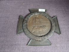 A WW1 Memorial Plaque to John Corless in metal cross frame, on reverse entitled to The Military