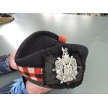 A WWII period Kings Own Scottish Borderers Glengarry Hat and Badge with Tartan backing