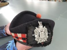 A WWII period Kings Own Scottish Borderers Glengarry Hat and Badge with Tartan backing