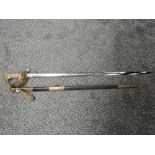 A British Naval Officers Sword with metal scabbard, sword has lion's head pommel and enclosed hilt