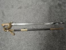 A British Naval Officers Sword with metal scabbard, sword has lion's head pommel and enclosed hilt
