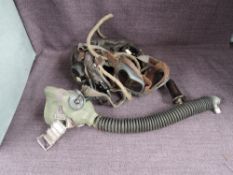 A possible WWII Leather Flying Helmet with goggles and oxygen mask, no marking seen