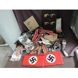 A collection of German WWII Medals, Arm Bands, Cloth Badges, Metal Badges, all thought to be