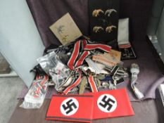 A collection of German WWII Medals, Arm Bands, Cloth Badges, Metal Badges, all thought to be