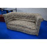 An early 20th Century Knowle style settee having shaped frame in paisley upholstery