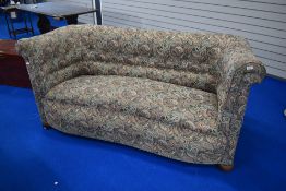 An early 20th Century Knowle style settee having shaped frame in paisley upholstery