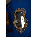 A vintage gilt frame wall mirror having foliate scroll design