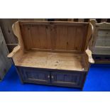A natural pine box settle, having doors to front , width approx. 107cm