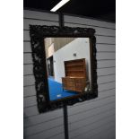 A Victorian Gothic mirror with highly carved foliate frame work.