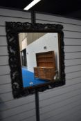 A Victorian Gothic mirror with highly carved foliate frame work.