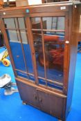 An early 20th century oak book case and cupboard with glazed doors.