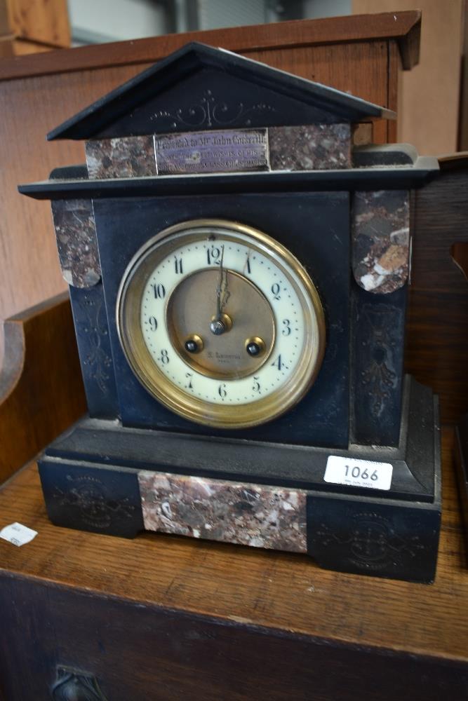 A Victorian black slate mantel clock having engraved white metal plaque for 1889 and brass centre