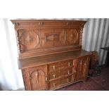 A late Victorian Gillow's of Lancaster oak sideboard, with raised and panelled back with barley