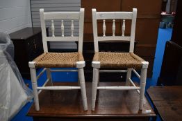 A pair of 19th Century painted childs spindle back chairs