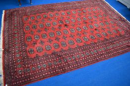A traditional carpet square having red ground, approx. 270 x 186cm
