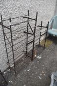 Two vintage wrought iron wine racks.