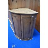 A traditional rustic pine bow fronted corner cupboard, height approx. 94cm