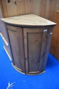 A traditional rustic pine bow fronted corner cupboard, height approx. 94cm