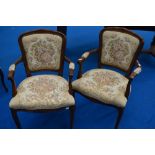A pair of reproduction Continental style armchairs with tapestry style upholstery