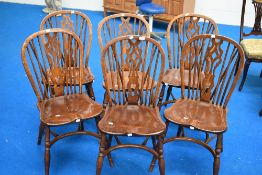 A set of six traditional stick back kitchen chairs having crinoline stretchers