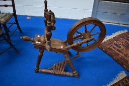An early 20th century Beech wood framed spinning wheel.