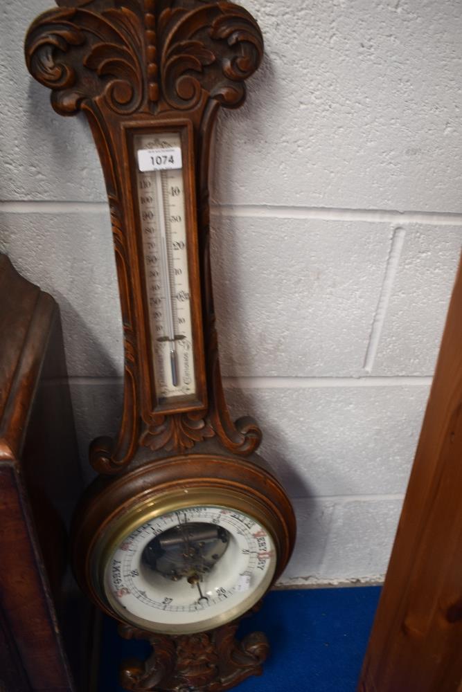 A late 19th or early 20th Century barometer having carved case and enamelled dial