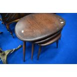 A vintage dark stained Ercol pebble style nest of tables