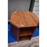 An early 20th Century oak occasional table with bookshelf under